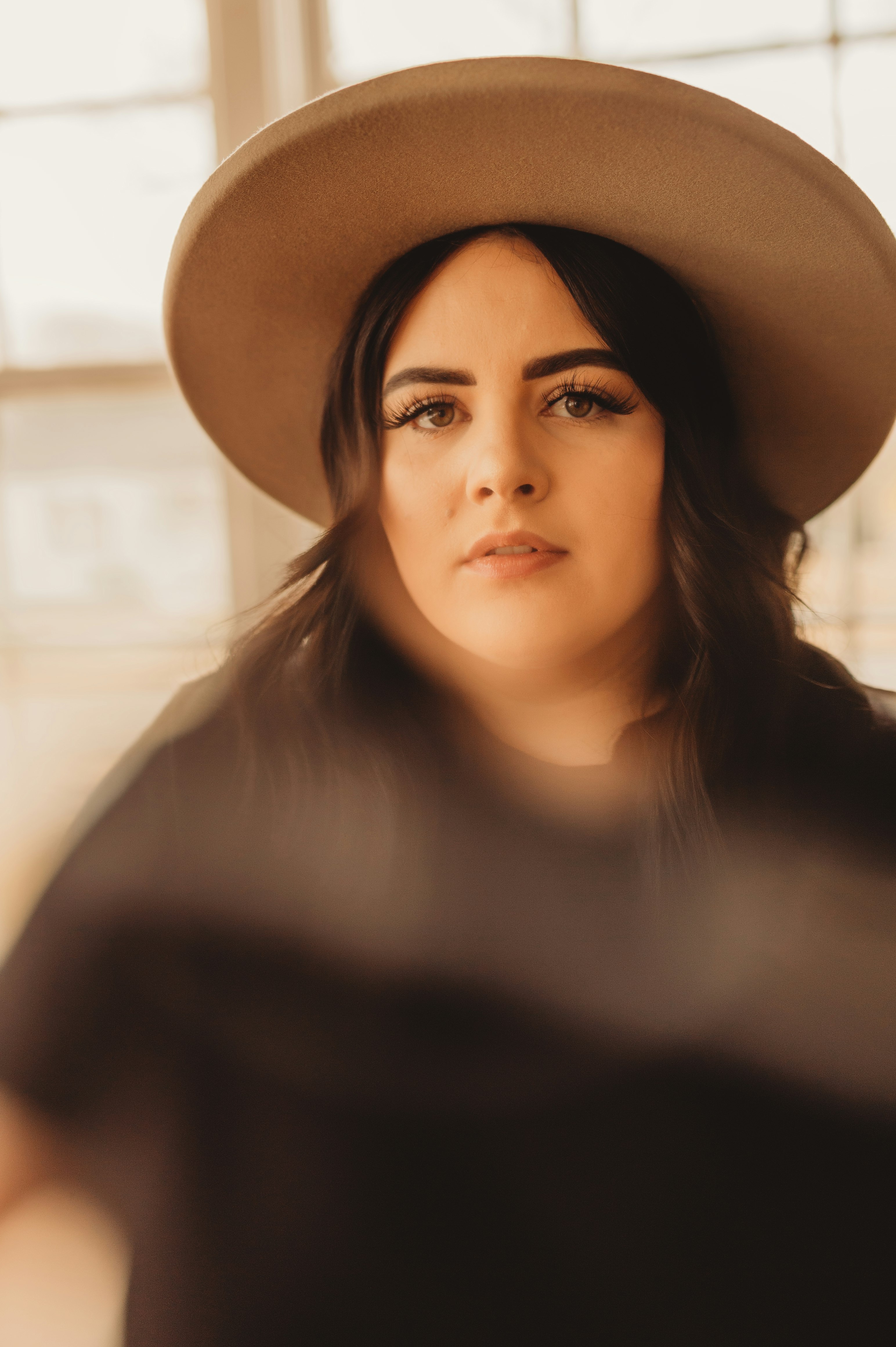 woman in black shirt wearing black hat